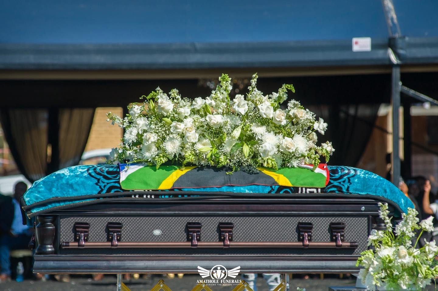A casket dressed in white lilies at an Amathole Funerals ceremony